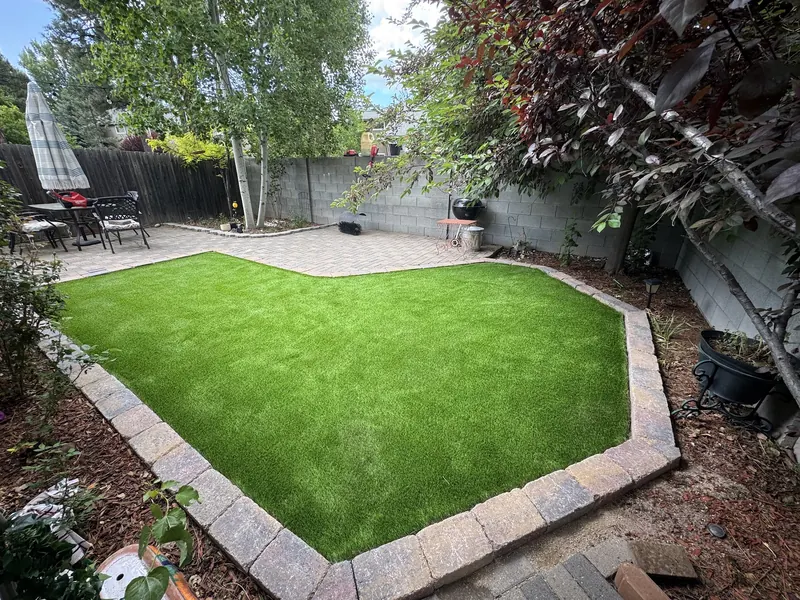 Artificial turf framed by a paver border