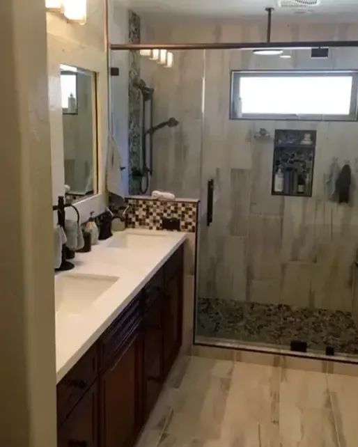 Primary bath with a double vanity and glass walk-in shower