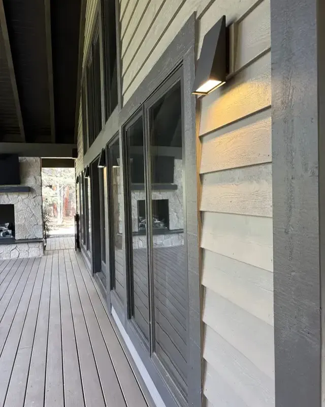 Covered deck walkway with new siding and windows